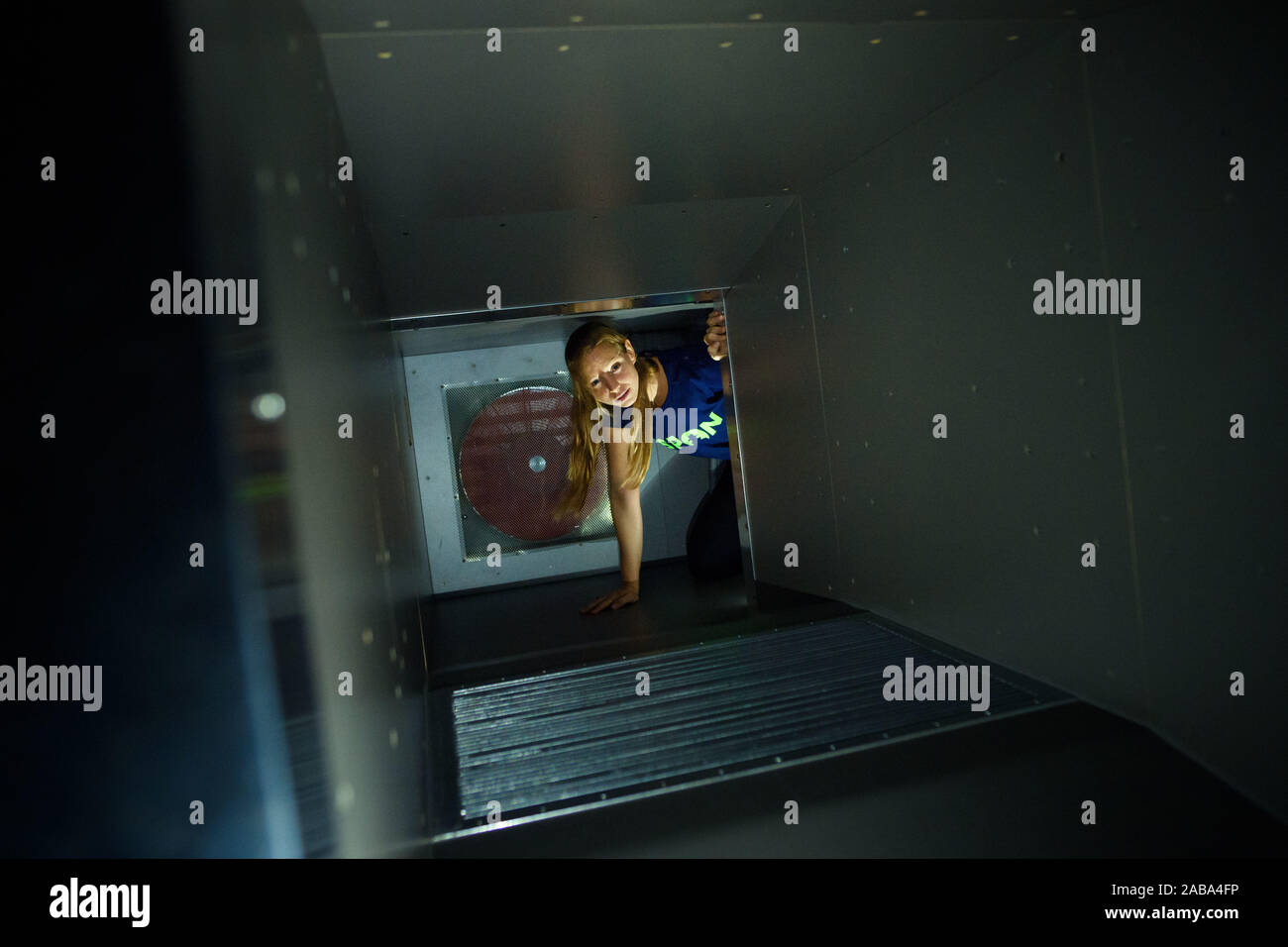 Berlin, Germany. 26th Nov, 2019. An employee of the museum crawls through a reconstructed ventilation shaft in the converted permanent exhibition in the German Spy Museum. Credit: Gregor Fischer/dpa/Alamy Live News Stock Photo