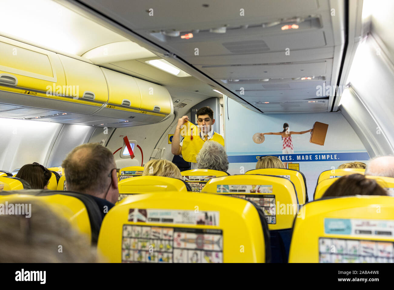 Safety demonstration by cabin crew stewerd on board a Ryanair Boeing 737 flight from Cork Airport, Ireland Stock Photo