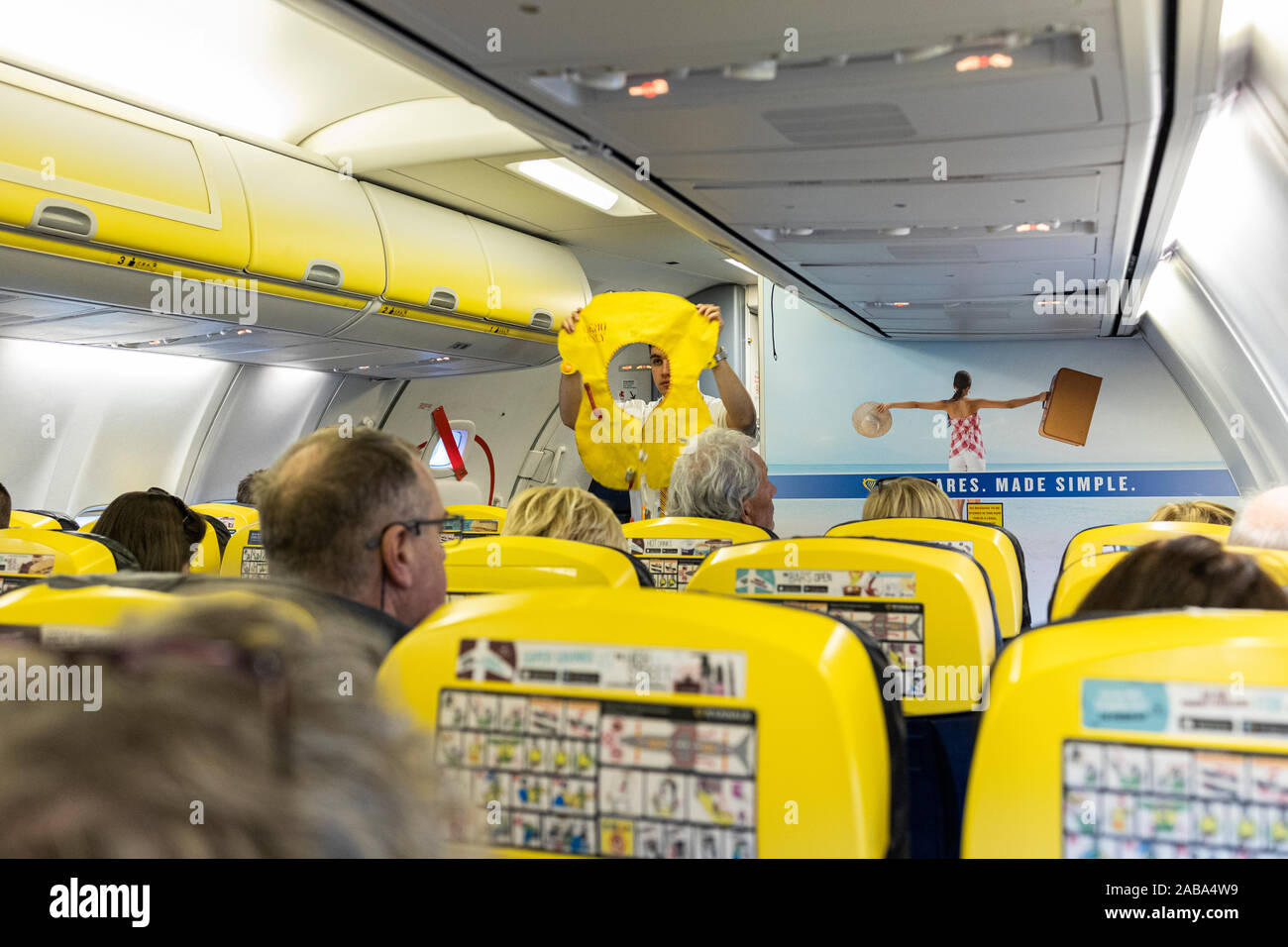 Safety demonstration by cabin crew stewerd on board a Ryanair Boeing 737 flight from Cork