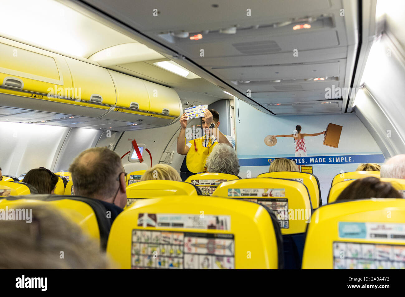 Safety demonstration by cabin crew stewerd on board a Ryanair Boeing 737 flight from Cork