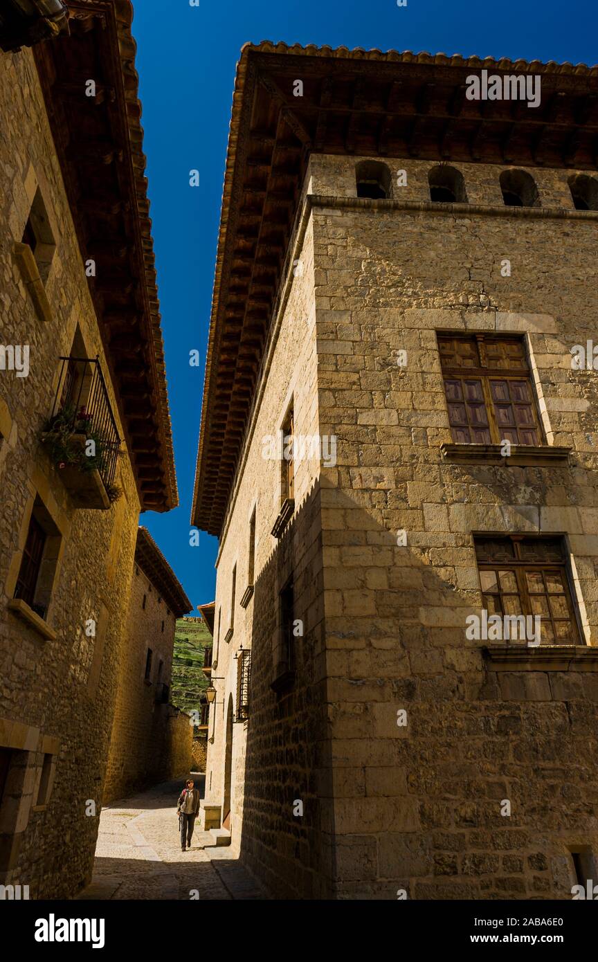 Tourist walking in medieval streets of Mirambel town (Teruel province, Aragón, Spain) Stock Photo
