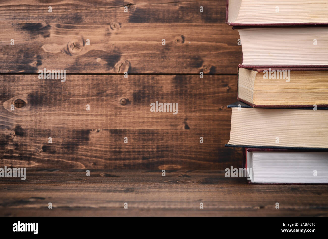 Old Law books on the brown wooden background, brown wooden backdrop Stock Photo