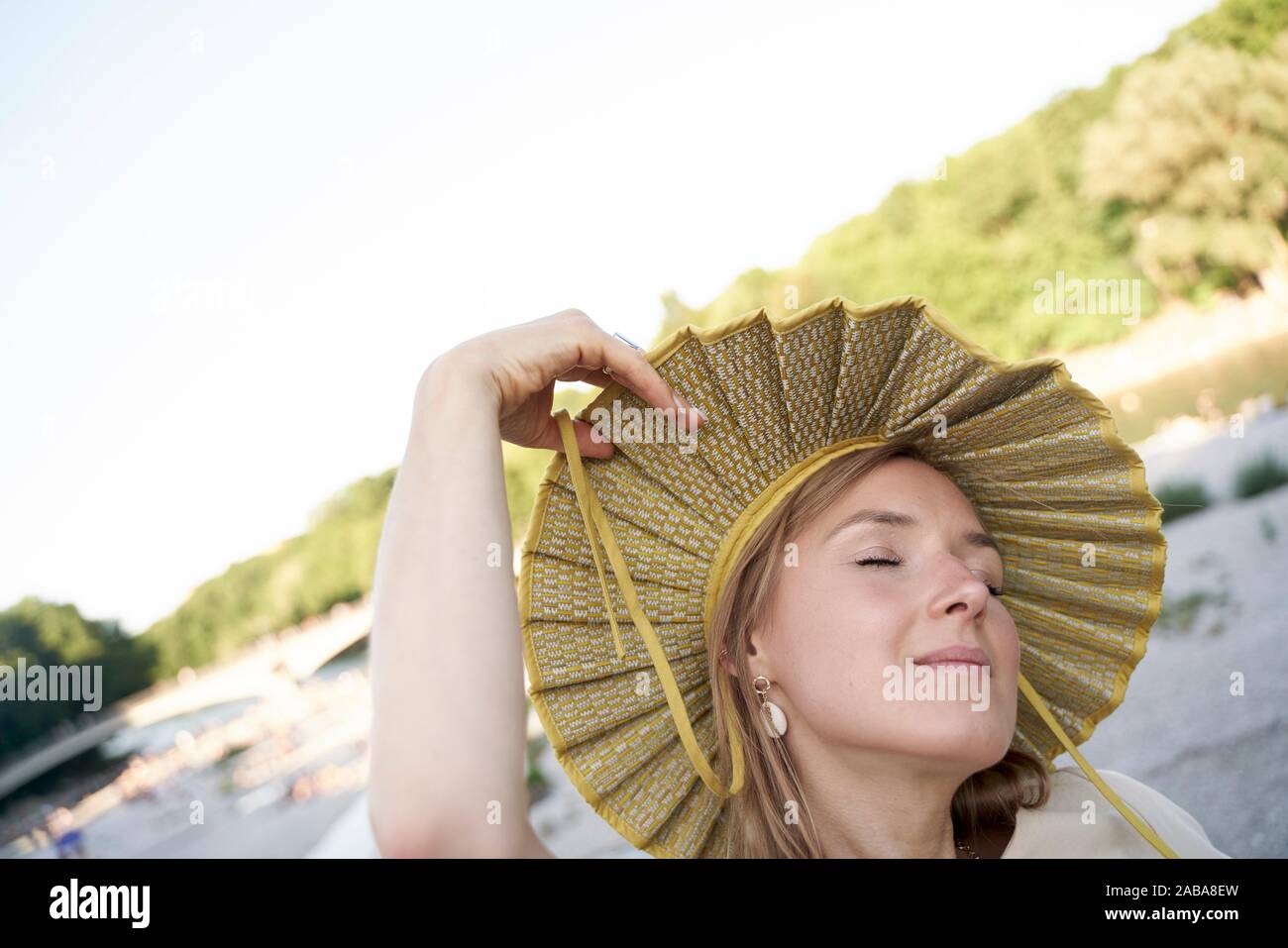 woman with big dreams and fashionable hat. Munich, Germany Stock Photo
