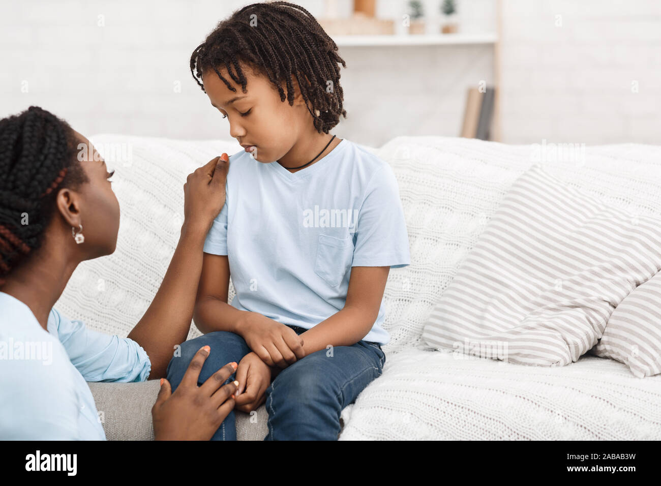 Black woman saying sorry to her daughter Stock Photo - Alamy