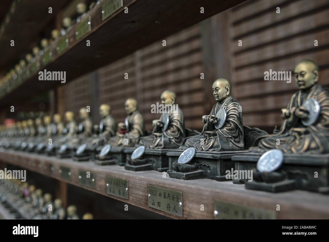 Rows of little Buddha statues in Daisho-in temple on the island of Miyajima, Japan. Stock Photo