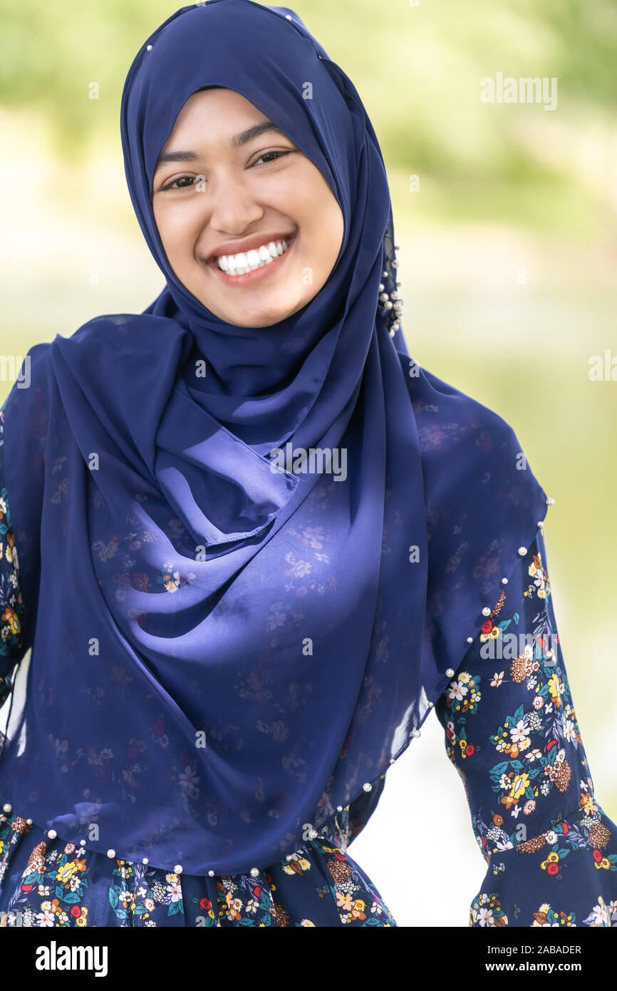 Portrait of good-looking Happy young teenager Muslim islamic asian university girl Stock Photo
