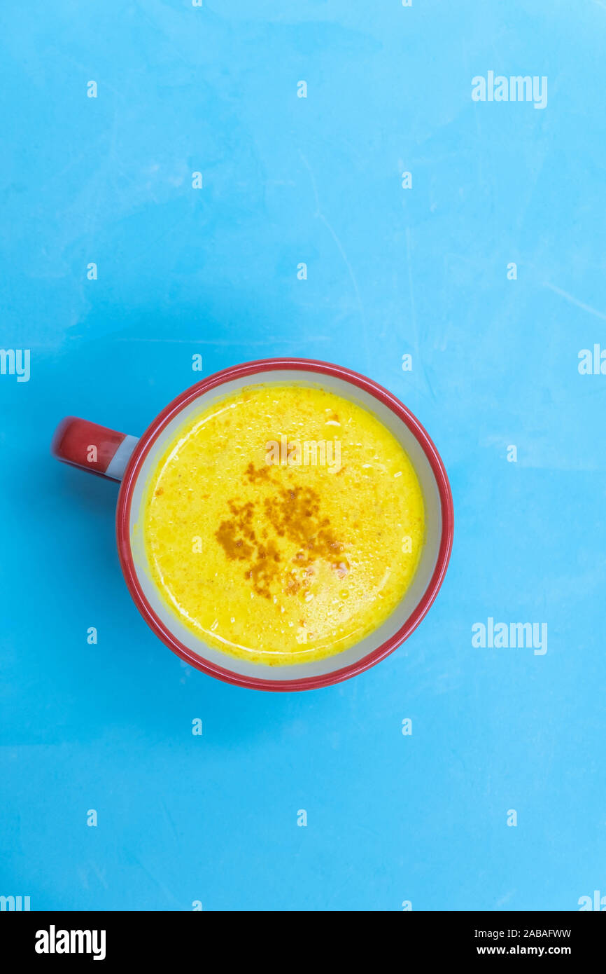 Ayurvedic drink turmeric golden milk on blue background Stock Photo Alamy