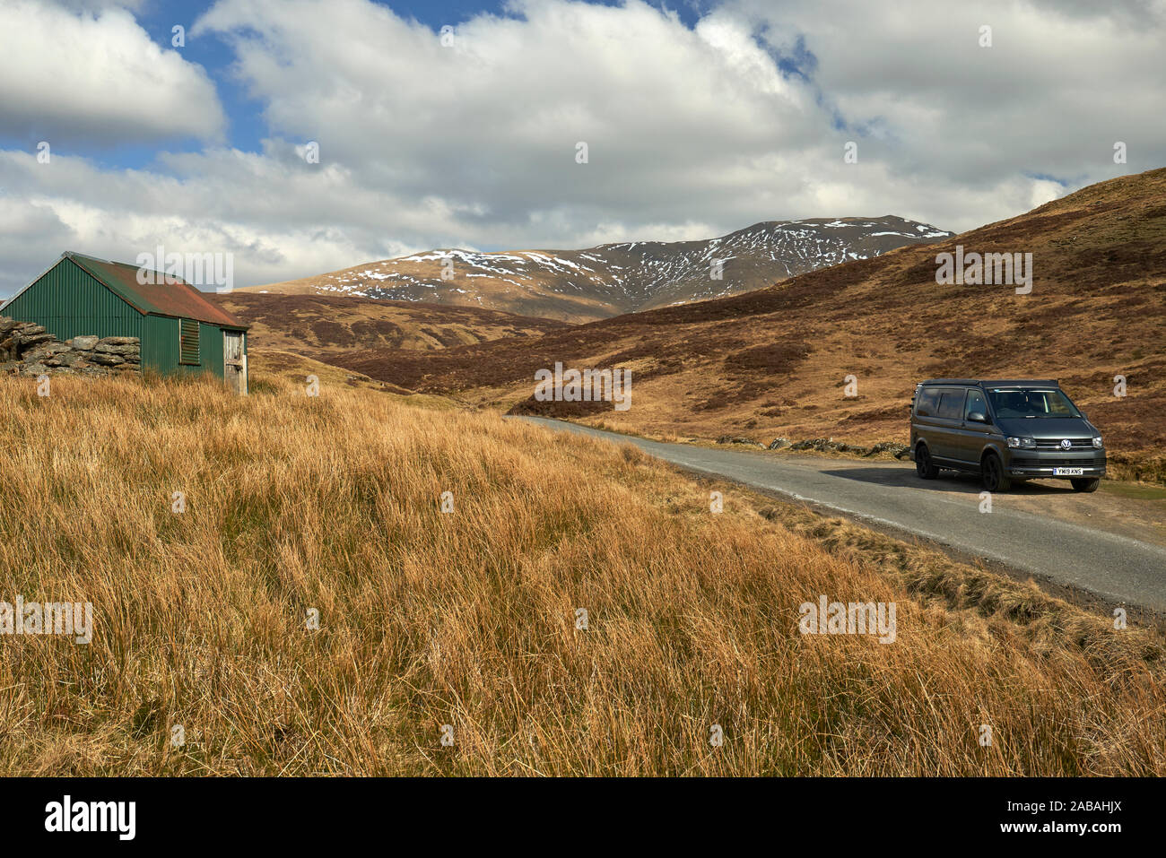 VW Campervan parked in passing place on a remote and pretty road in the ...