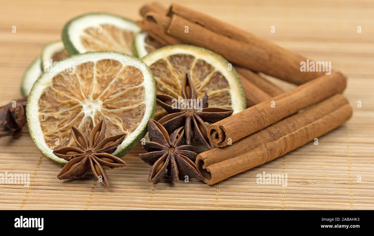 Anise stars, lemon slices and cinnamon sticks Stock Photo