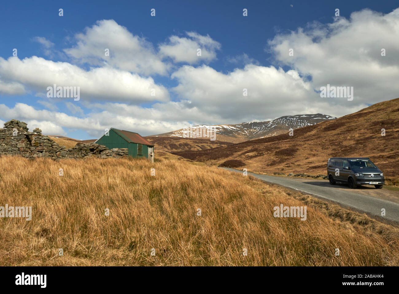 VW Campervan parked in passing place on a remote and pretty road in the ...