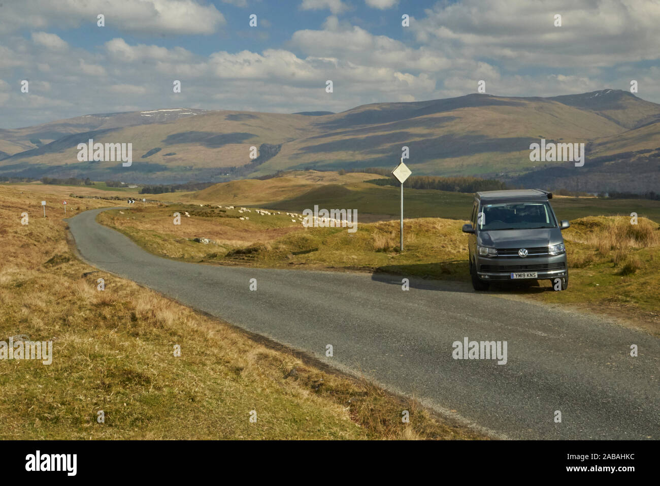 VW Campervan parked in passing place on a remote and pretty road in the ...