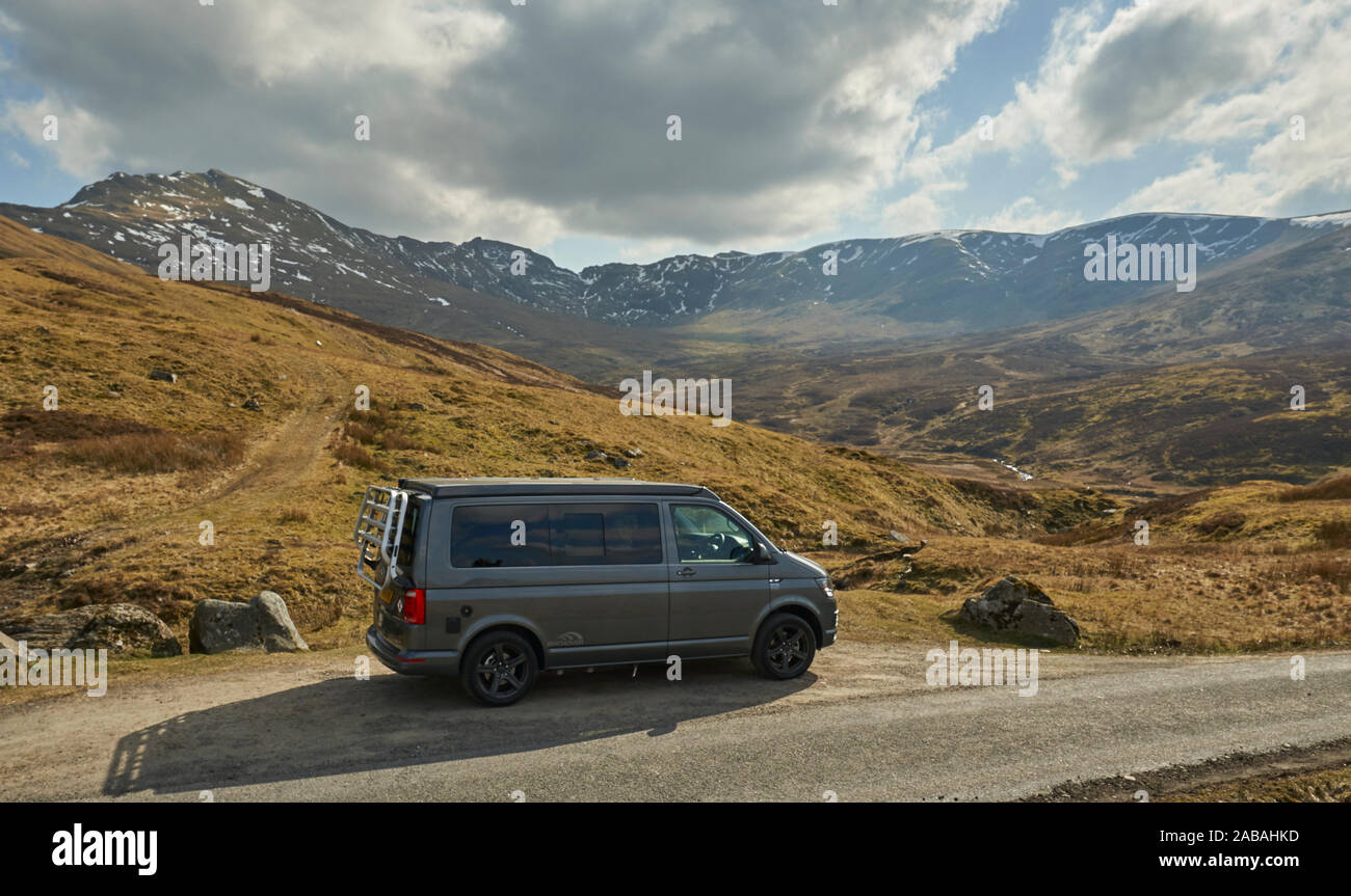 VW Campervan parked in passing place on a remote and pretty road in the ...
