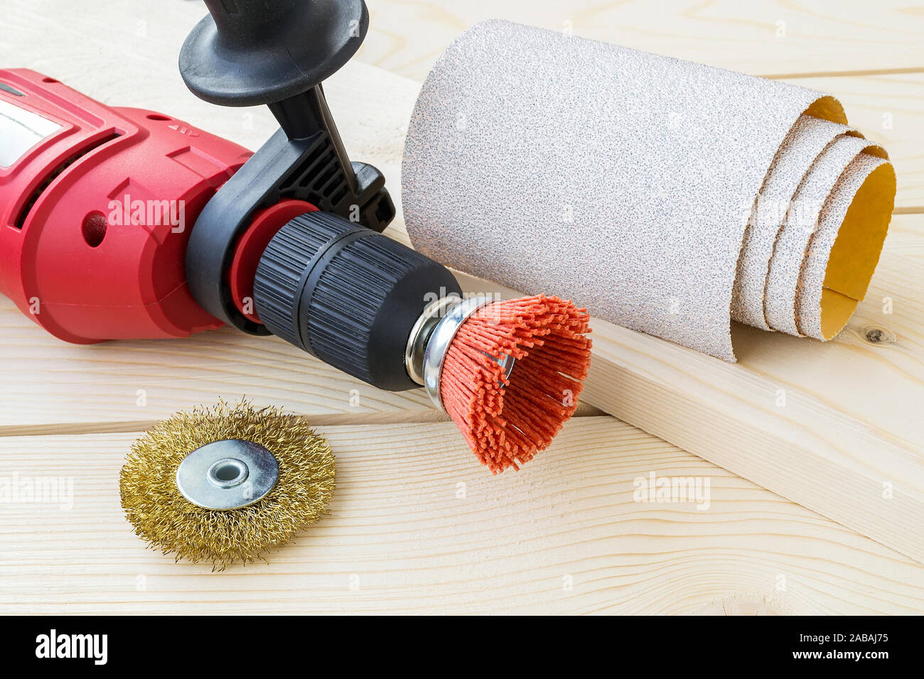 Red drill, sandpaper and abrasive brushes with nylon and metal wire on