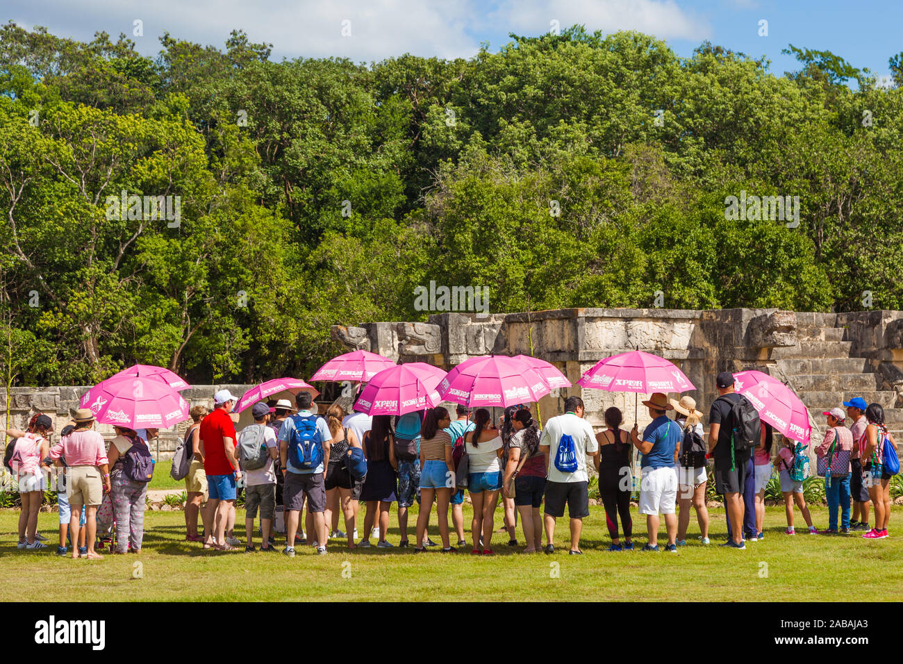 Group of tourists at the Temple of the Jaguar on the Mayan Chichen Itza site in Mexico Stock Photo