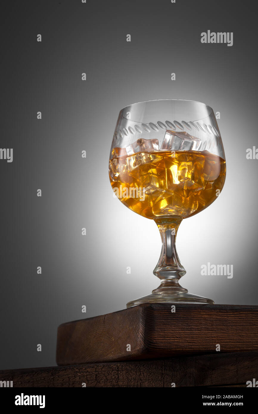 Orange drink with ice in winglass on the wooden table Stock Photo