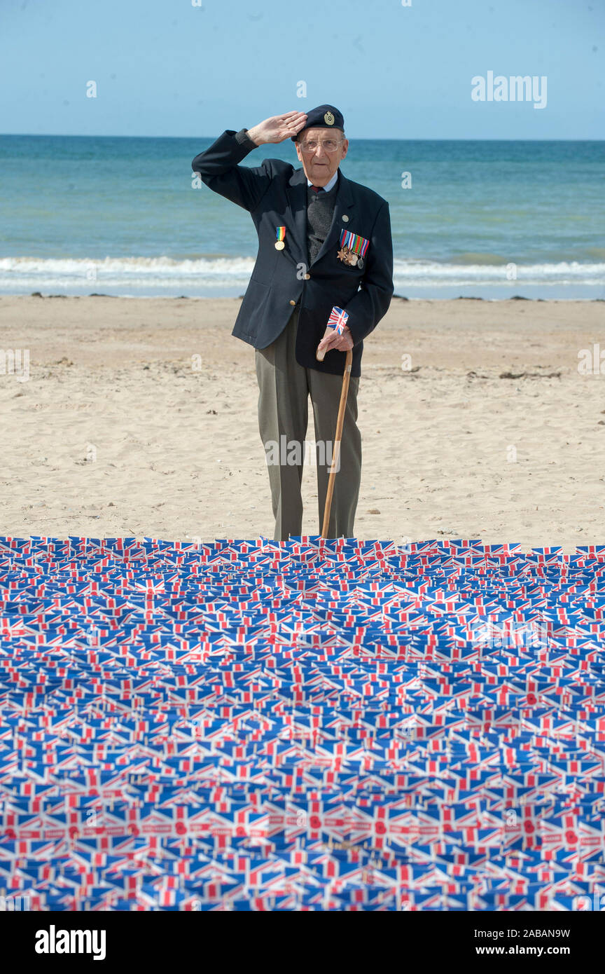 Cyril Ager a sapper from the Royal Engineers who landed on 'Gold Beach' D-Day plus half hour planting a flag in remembrance for the D- Day anniversary celebrations. June 5th 2014. Stock Photo