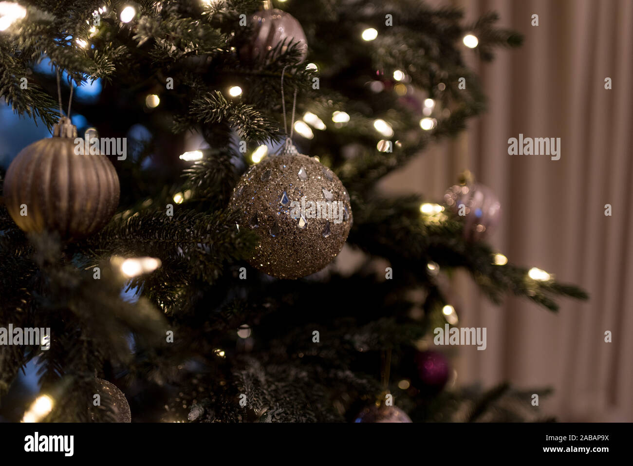 Christmas silver baubles on Christmas tree Stock Photo - Alamy