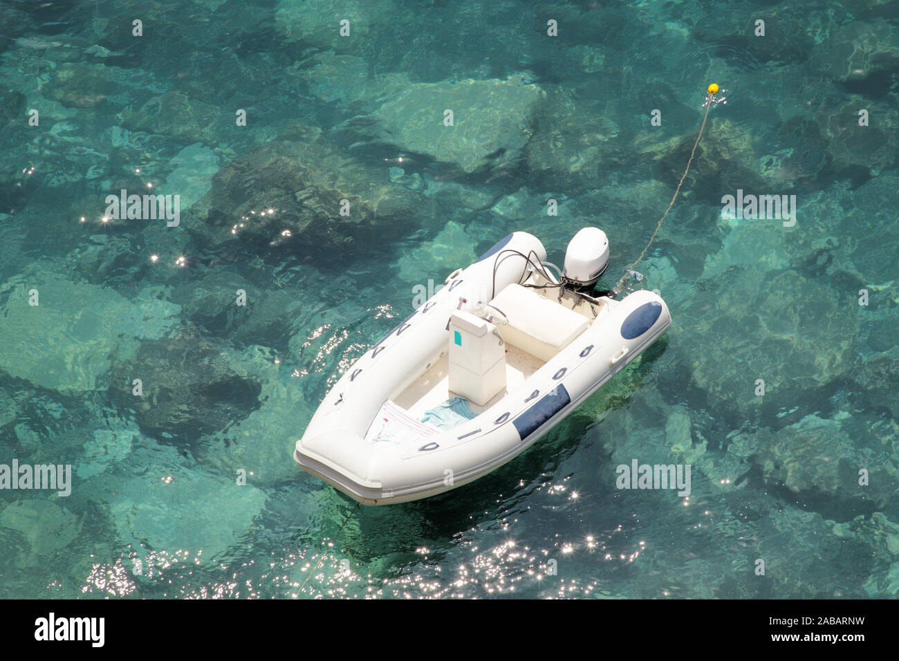 looking down at a small speed boat in the sea Stock Photo