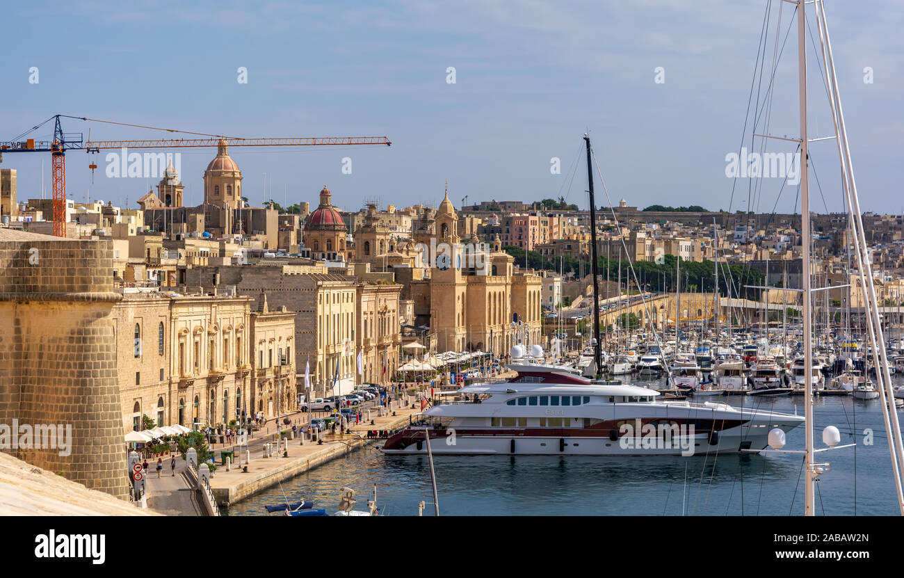 Yachts and boats anchored at Grand Harbour Marina of Birgu (Vittoriosa) in Malta, with embankment and Maritime Museu Stock Photo