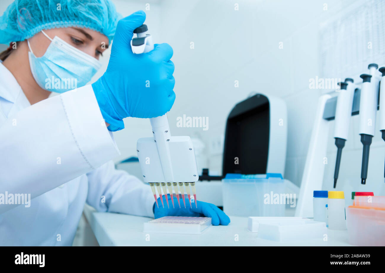 Woman collecting blood samples from pipette for testing Stock Photo Alamy