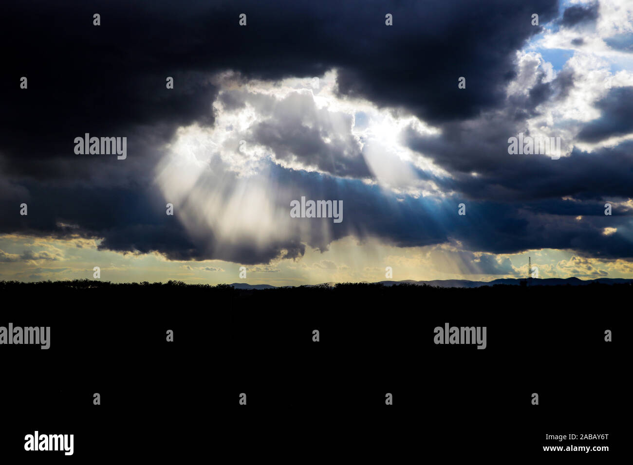 Sun rays through ominous clouds hi-res stock photography and images - Alamy