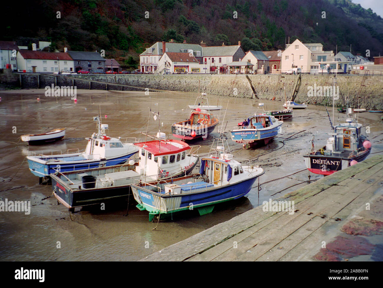 Group of fishing boats in a harbour and the tide is out Stock Photo - Alamy
