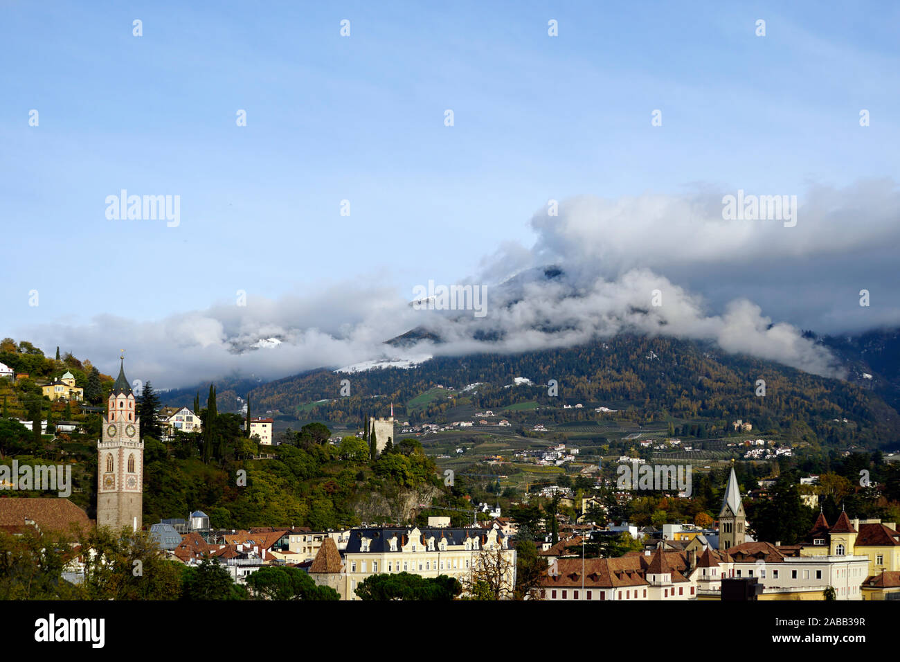 City of Merano and St. Nicolaus church in Merano in South Tirol, Italy. Cloudy autumn day. Stock Photo
