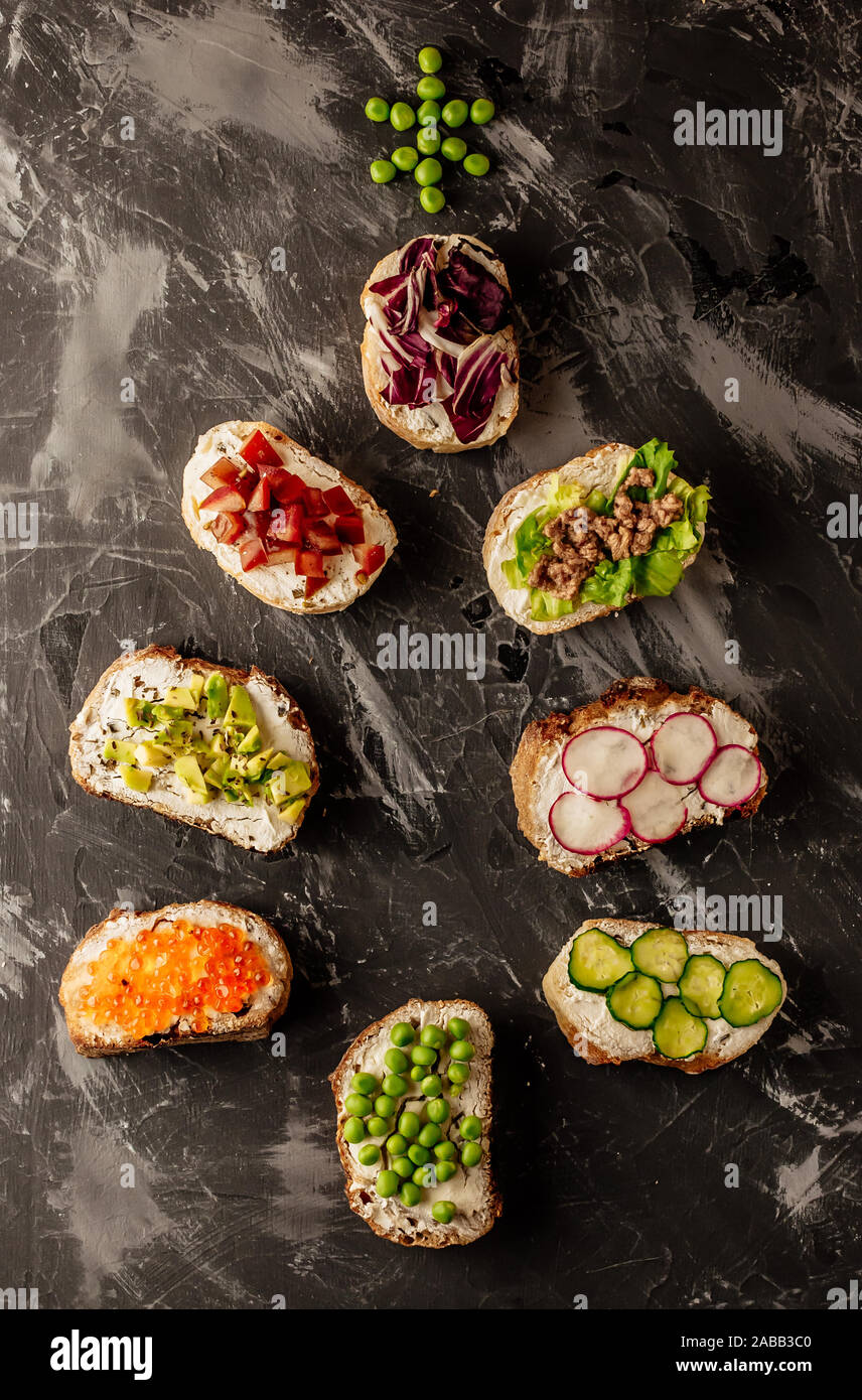 Brushetta or traditional spanish tapas. Appetizers italian antipasti snacks set on wooden board. Top view and flat lay with space for your text Stock Photo