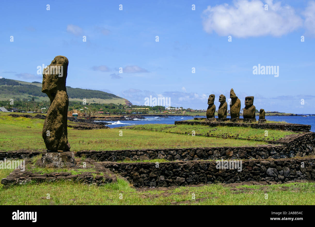 A scenic view of several Moai on Easter Island with the town of Hanga
