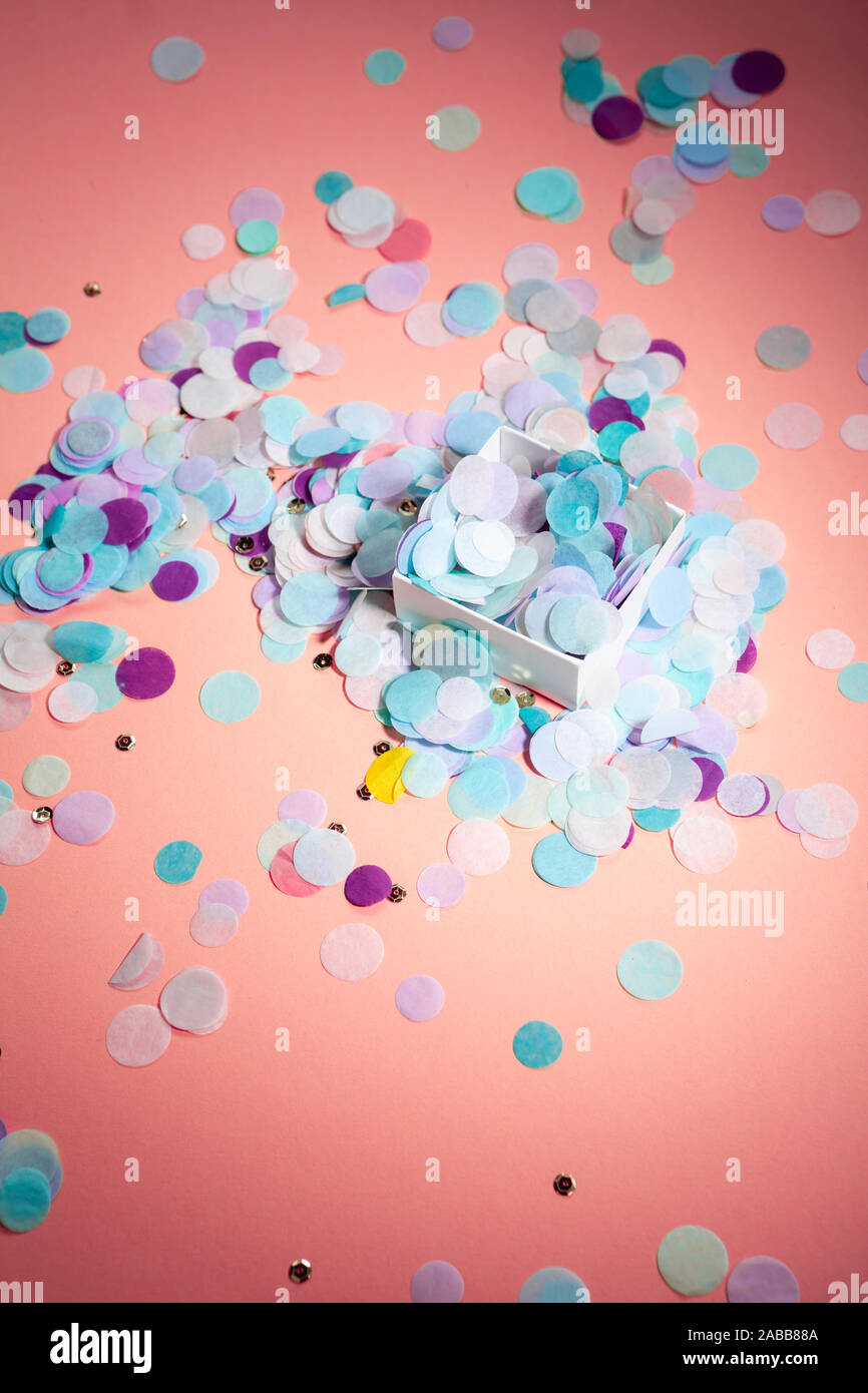 Pink background with color confetti in box, holiday Stock Photo Alamy