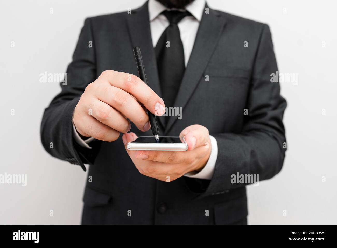 Male human wear formal work suit hold smart hi tech smartphone use one ...