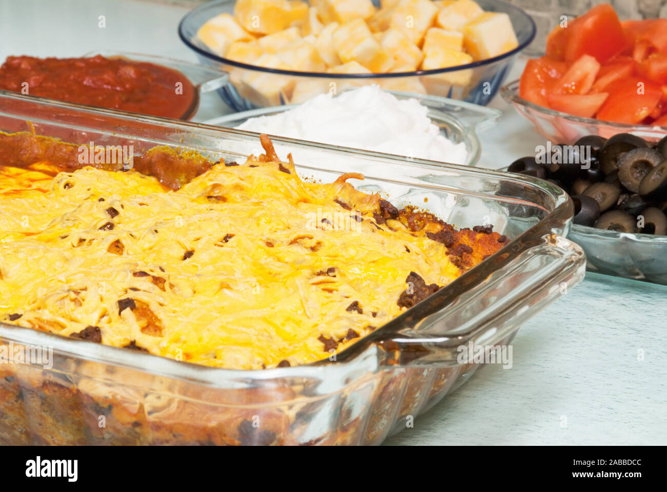 Mexican pizza casserole made with Colby cheese, tomatoes, black olives