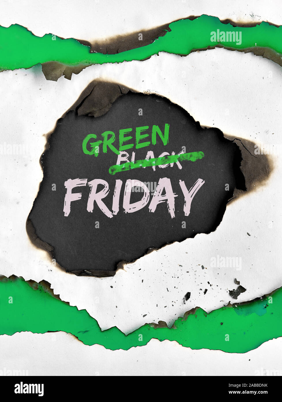 Green Friday concept, hole burned in white and green paper. Text 'Black Friday Sale'  with word 'Black' crossed out. Strikethrough or strikeout effect Stock Photo