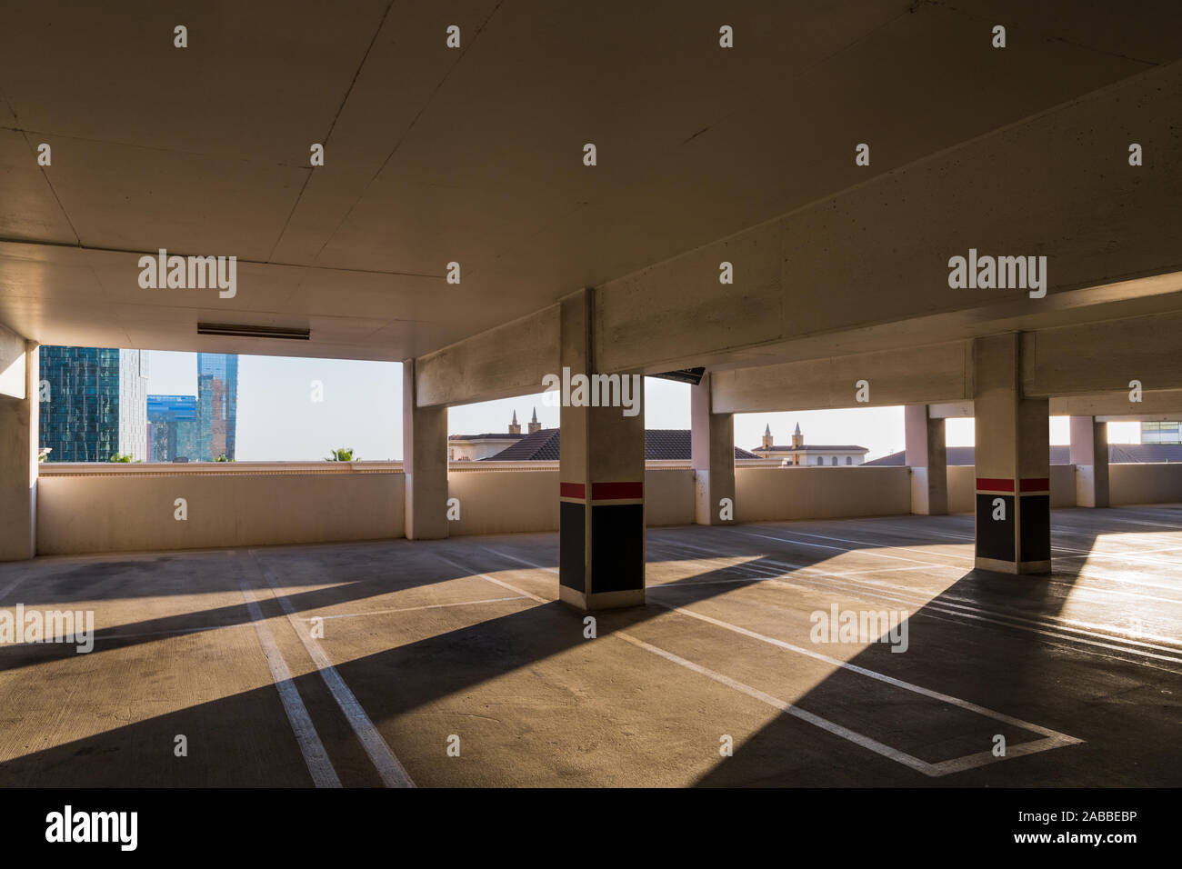 Empty parking garage with concrete columns creating dramatic areas of
