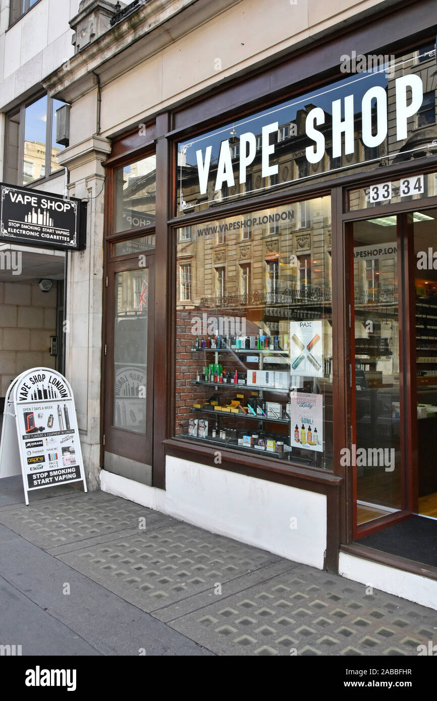 London vape shop front window & entrance folding A frame panel advertising  products electronic cigarettes & glass basement pavement lights England UK  Stock Photo - Alamy