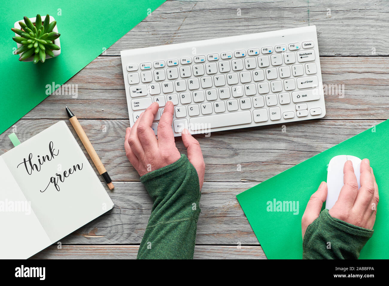 Think green, zero waste creative flat lay. Top view with hands typing