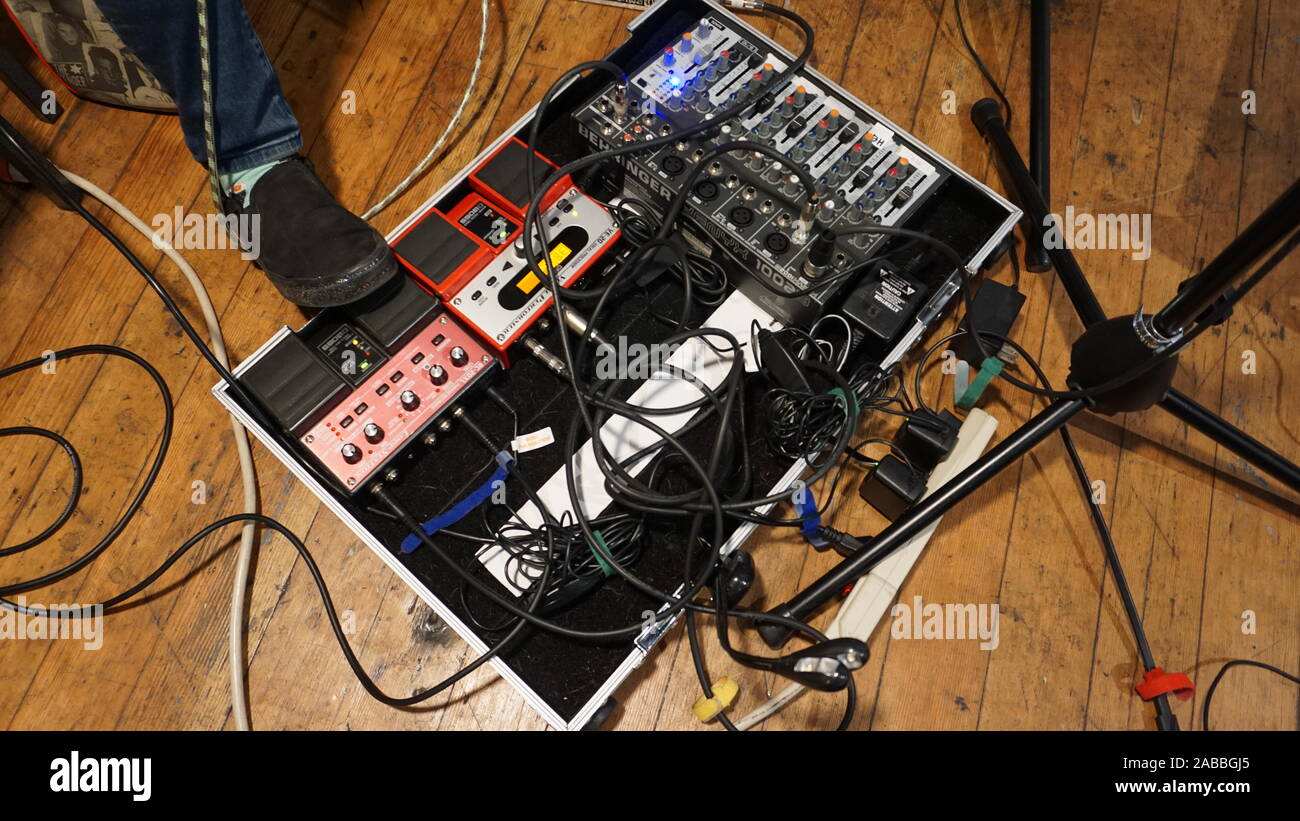 Live looping foot pedal station. Boss RC-20XL phrase recorder, Boss VE-20 vocal processor, Behringer Xenyx 1002B analog audio mixer with XLR cables. Stock Photo