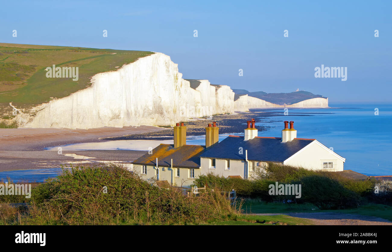 The classic 'cottage view' of the Seven Sisters on the South Downs coast. Stock Photo