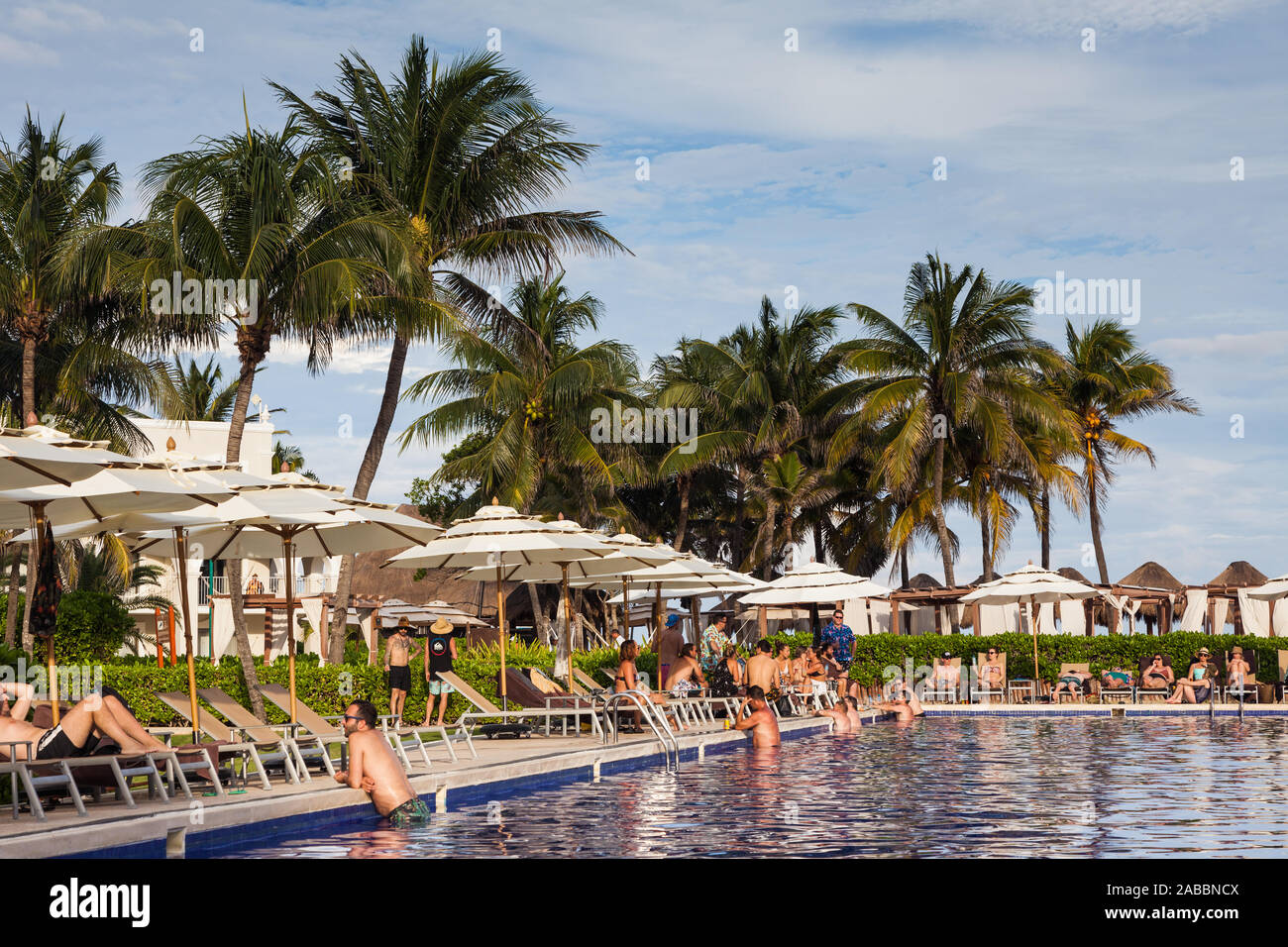 People On Vacation Relaxing Around A Resort Swimming Pool On The