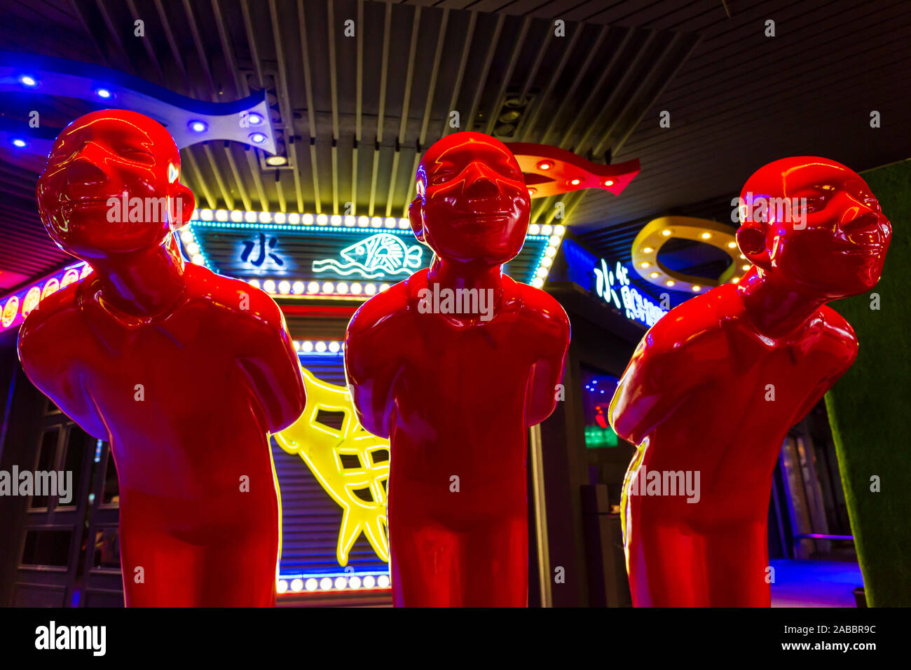 Taoyuan, Taiwan - November 12, 2019: Three red men statues outside a restaurant near the Zhongli Night Market in Taoyuan, Taiwan. Stock Photo