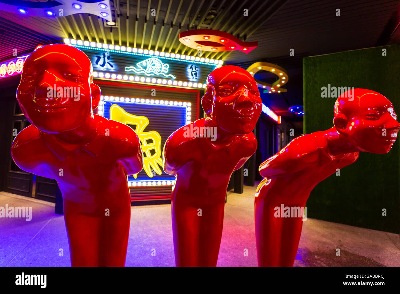Taoyuan, Taiwan - November 12, 2019: Three red men statues outside a restaurant near the Zhongli Night Market in Taoyuan, Taiwan. Stock Photo