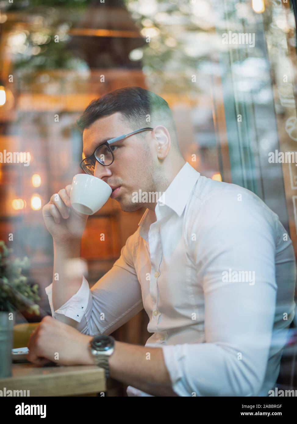 Intelligent young man drinking coffee Stock Photo