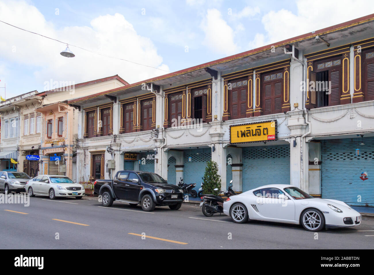 Phuket, Thailand - September 4th 2013: Cars parked outside Sino Portuguese architecture houses on Dibuk Road.  This is the heart of the Old Town. Stock Photo