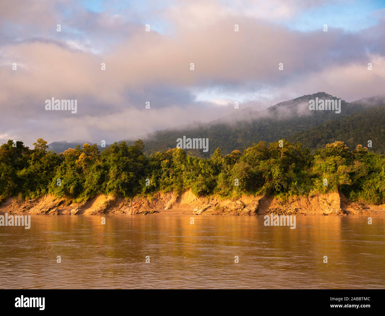 Landscape morning view of a mist rising over distant mountains while cruising on the Chindwin River in northwestern Myanmar (Burma) Stock Photo