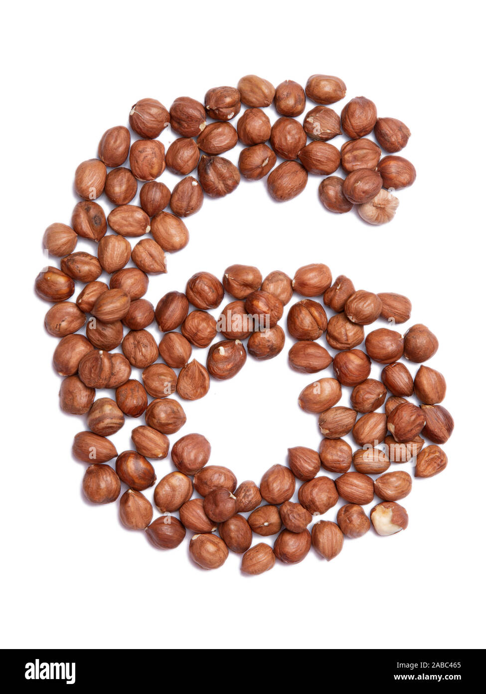 Arabic numeral "6" from peeled hazelnut on a white isolated background