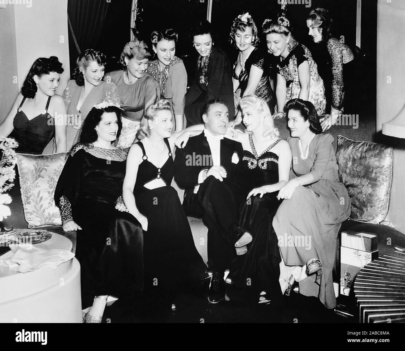 APPOINTMENT FOR LOVE, Charles Boyer amid the female extras on set, 1941 Stock Photo