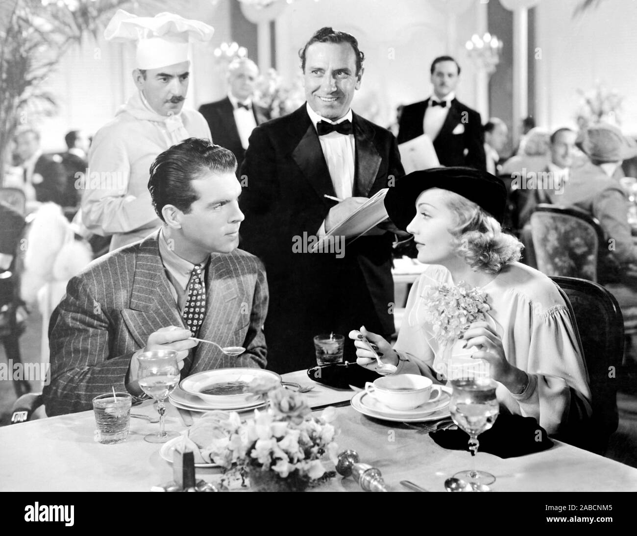 HANDS ACROSS THE TABLE, from left, seated, Fred MacMurray, Carole ...