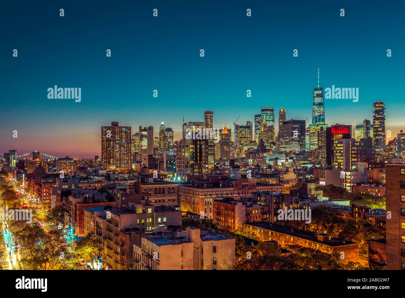 Lower Manhattan skyscrapers at sunset. Street with cars and Brooklin