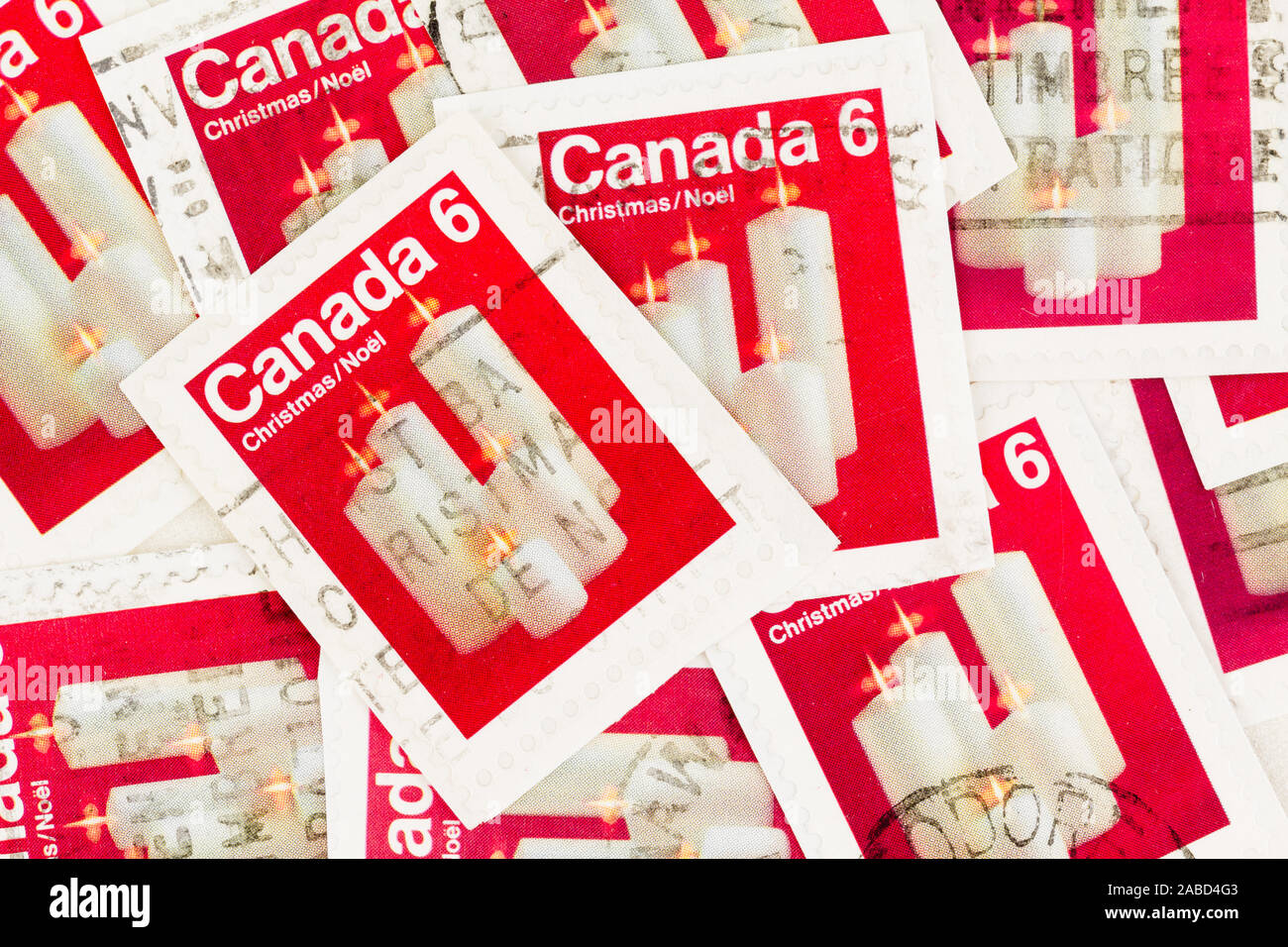 SEATTLE WASHINGTON -November 22, 2019: Christmas stamps of Canada on paper, featuring white candles on red background. Stock Photo