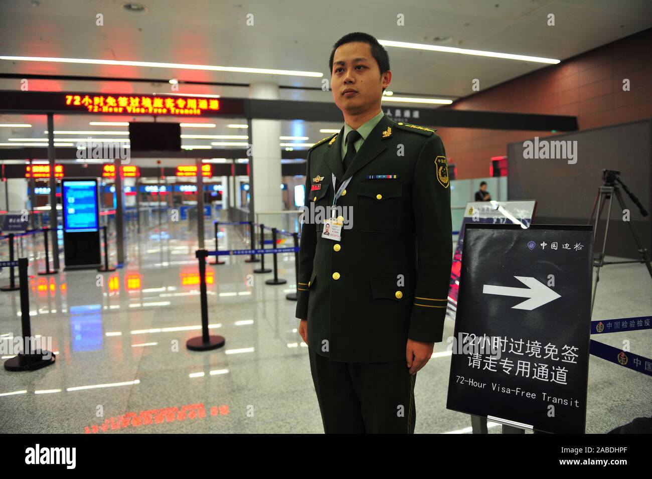 --FILE--A custom officer waits to help foreign foreigners to experience visa-free access at Shenyang Airport in Shenyang city, northeast China's Liaon Stock Photo
